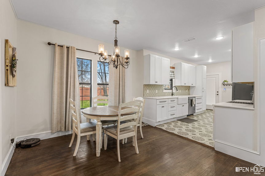 White modern kitchen with stainless appliances and vintage charm at 2234 Harrell St.