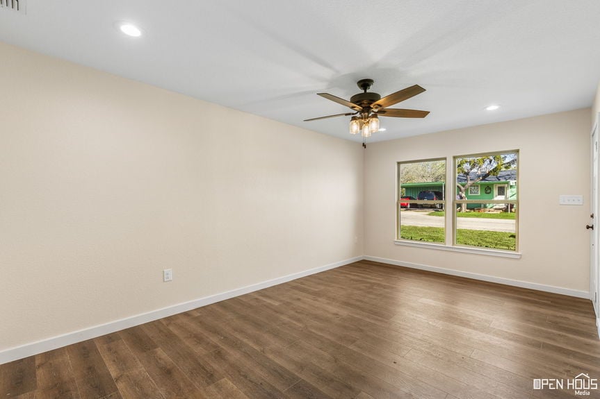 Interior of a bright living room with laminate flooring and a ceiling fan in a Jacksboro home.