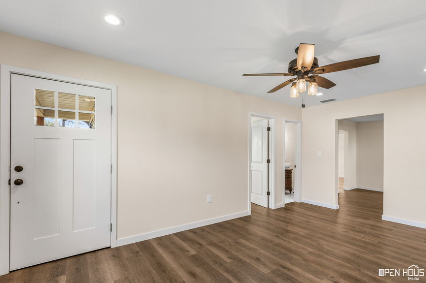 View from inside the home's entryway with a front door window pane and interior doors in Jacksboro, TX."