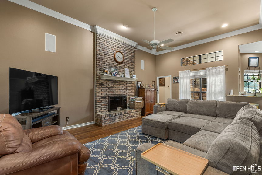 Main living room with tall ceilings and fireplace