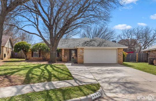 Front exterior of 4868 Matterhorn Dr showcasing a beautifully landscaped yard, covered entry, and charming curb appeal.