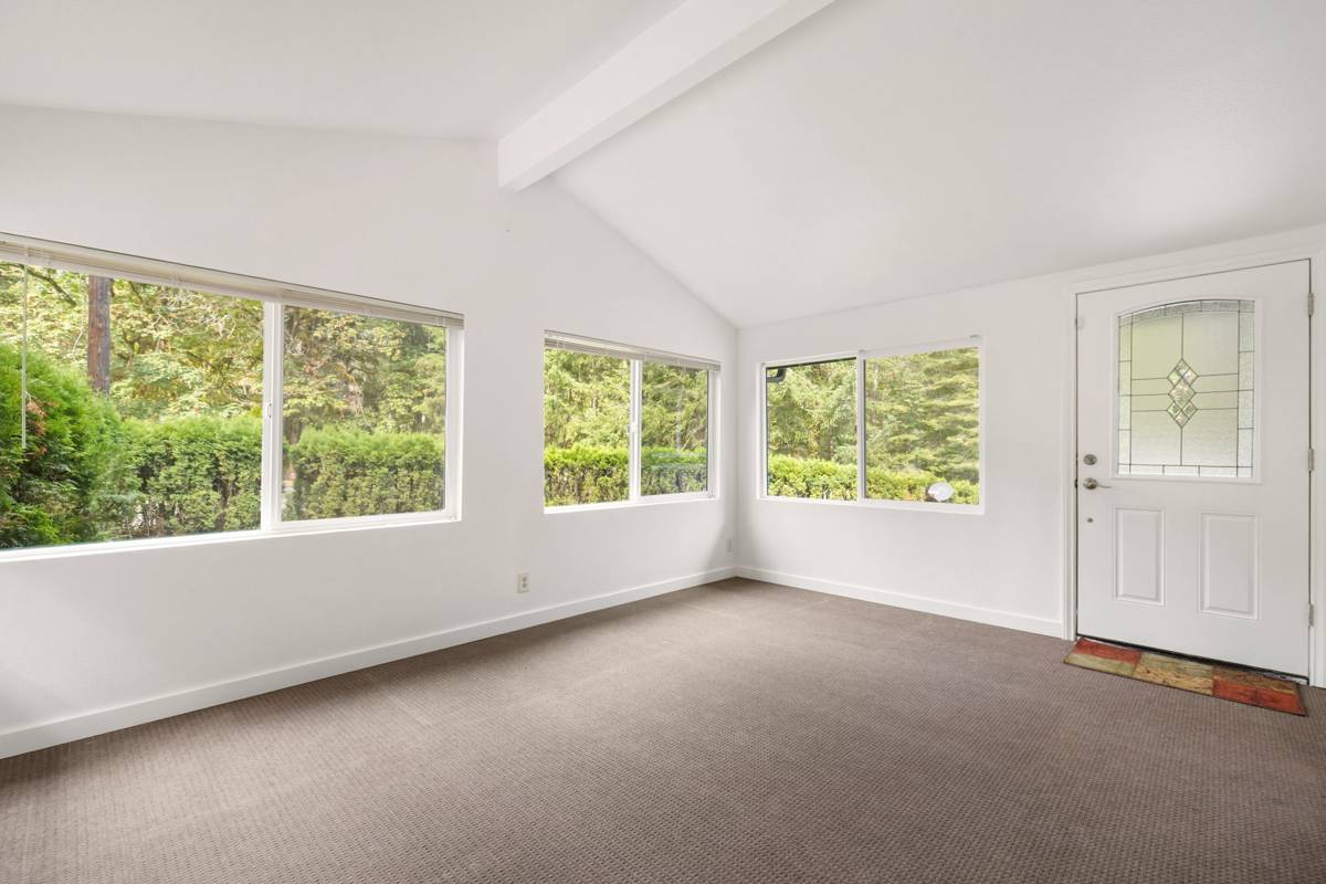 Sunroom with vaulted ceiling and windows on three sides