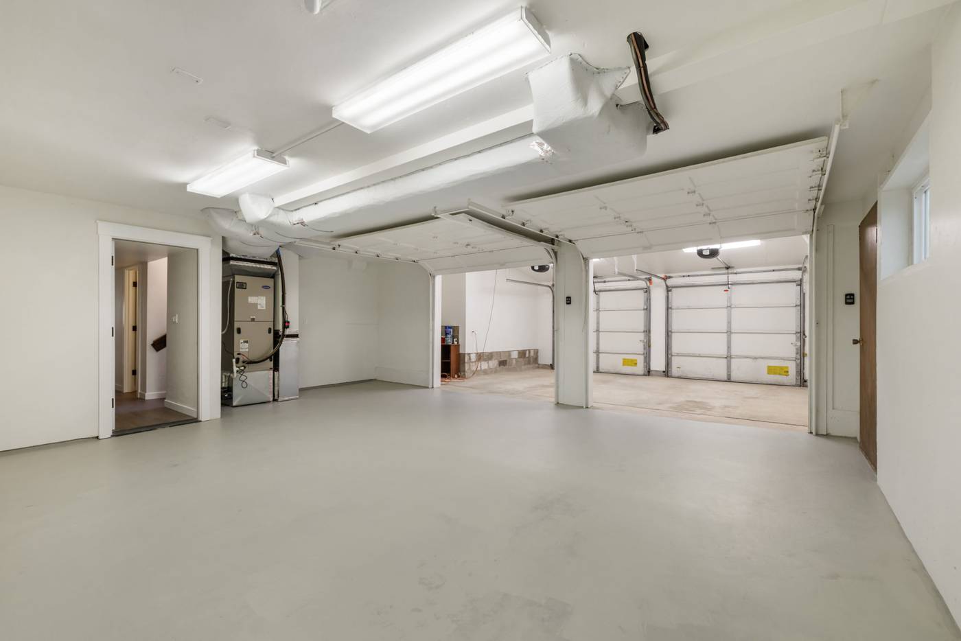 Attached garage with a second set of overhead doors midway through