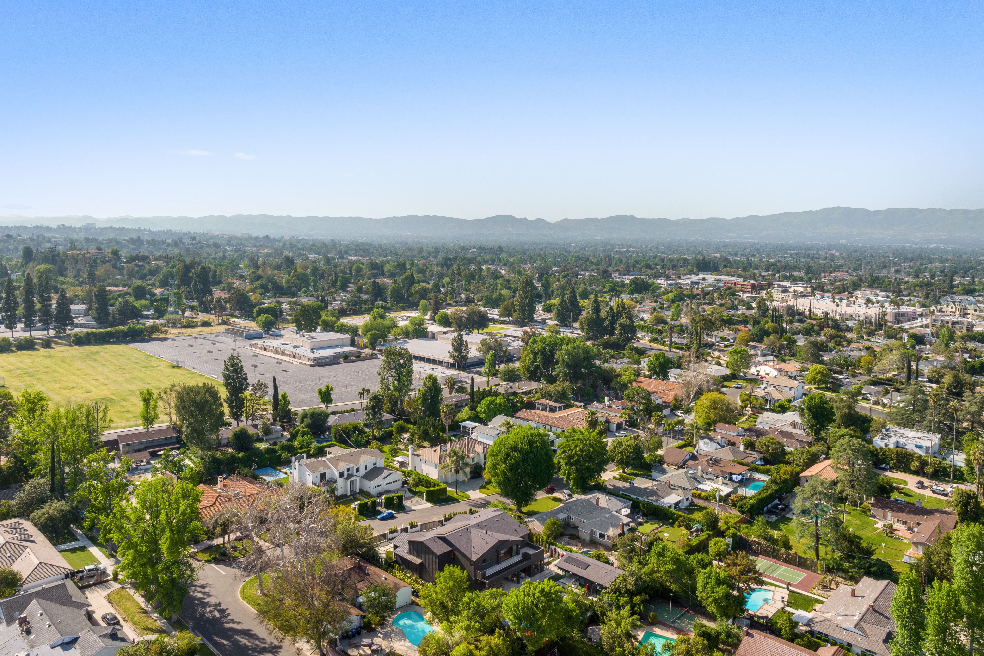 Aerial view of a suburban neighborhood with a school field.