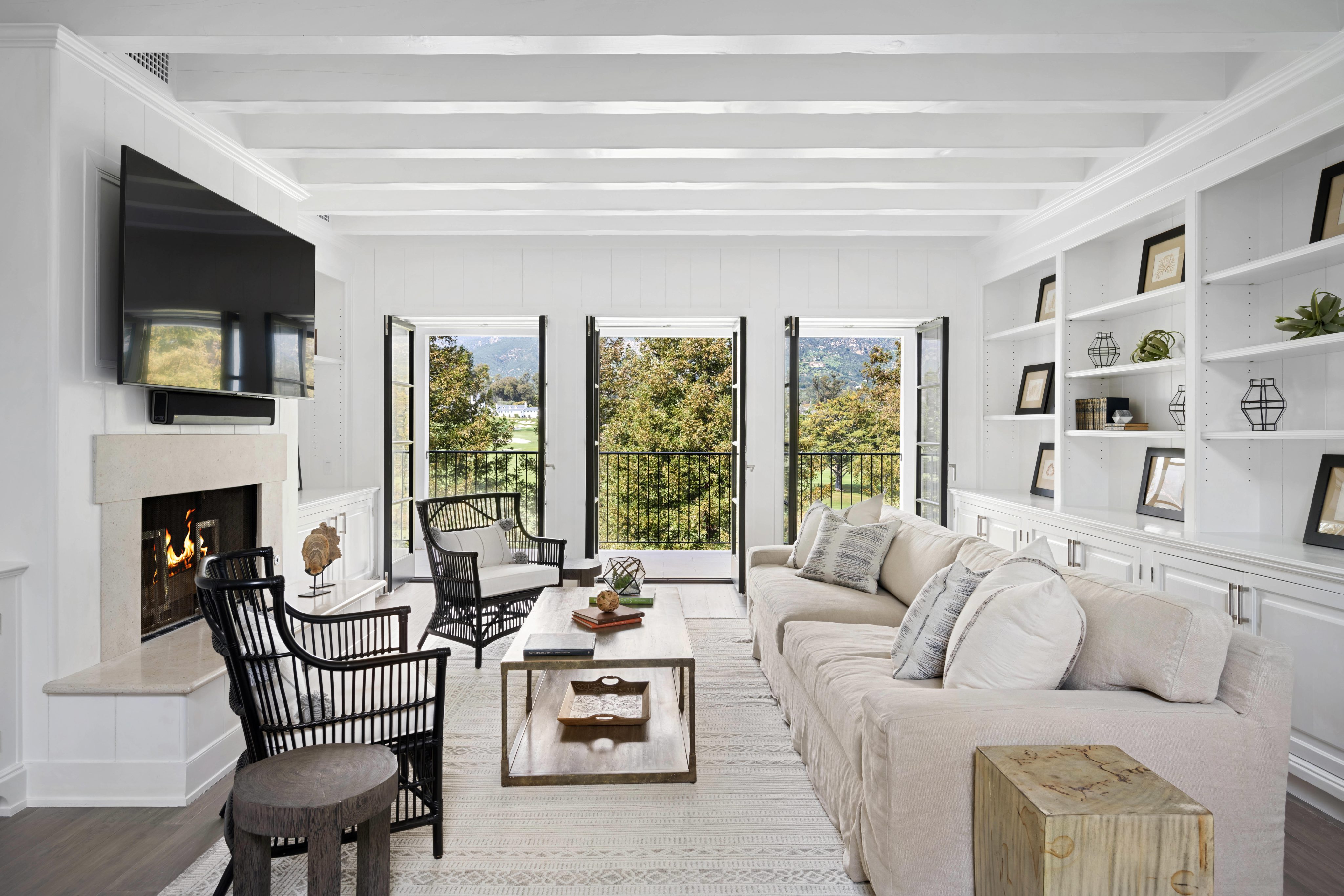 White couches and ample windows in a well-furnished living room