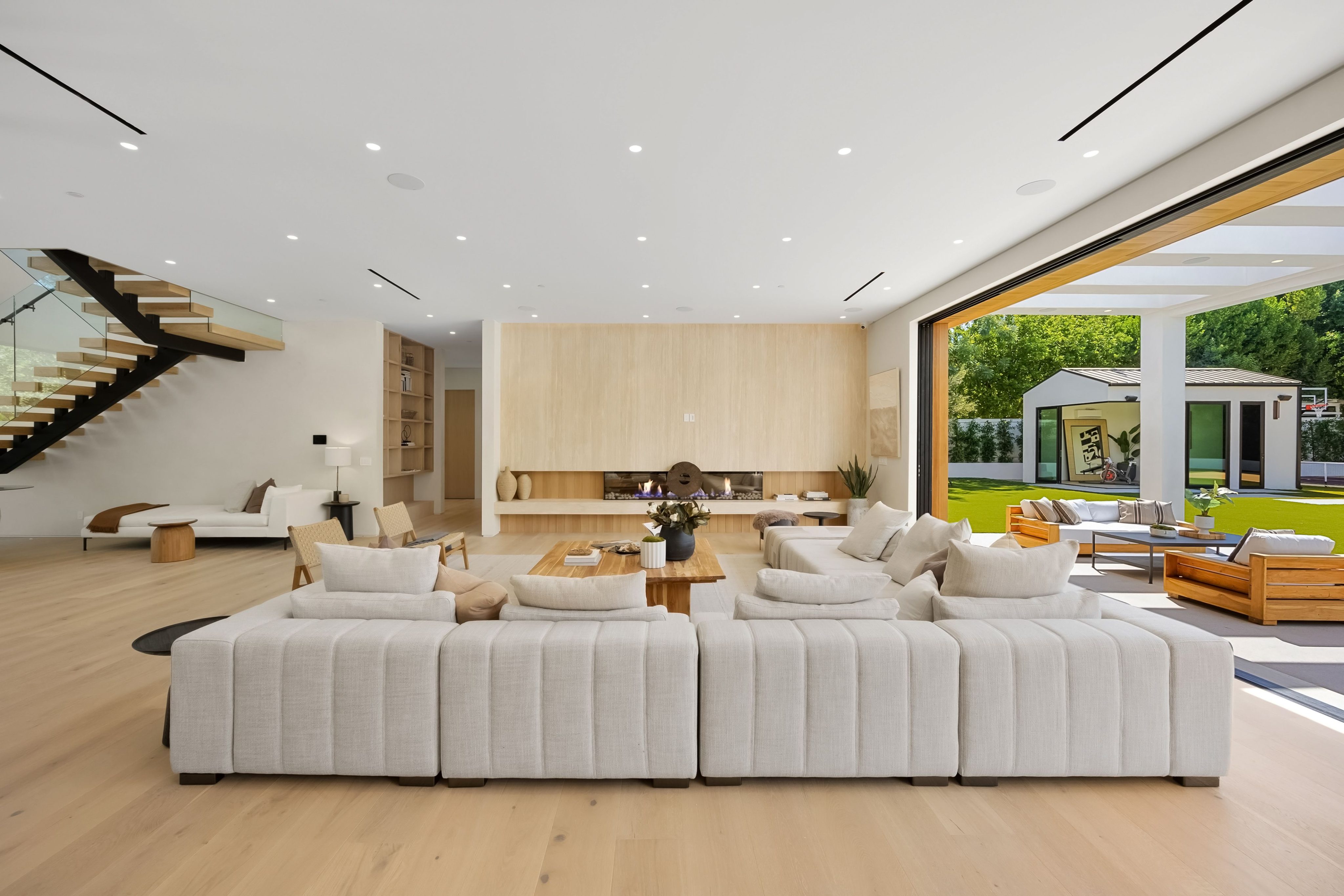 Modern living room with open space design and garden view.