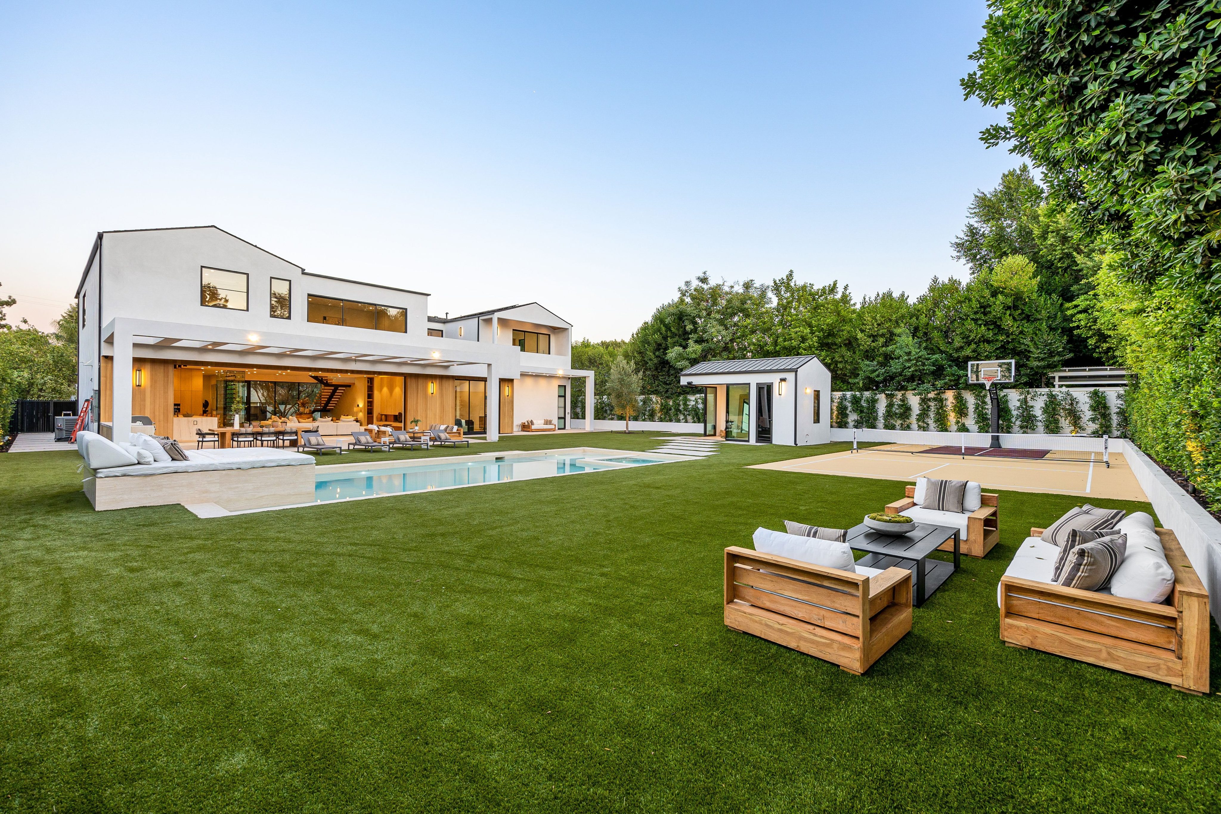Modern luxury home with backyard and pool.