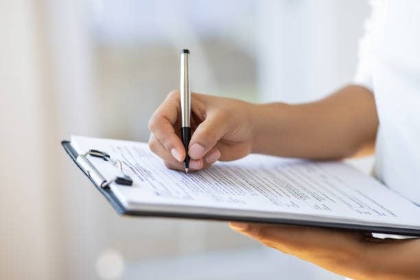 Holding clipboard and a pen in office