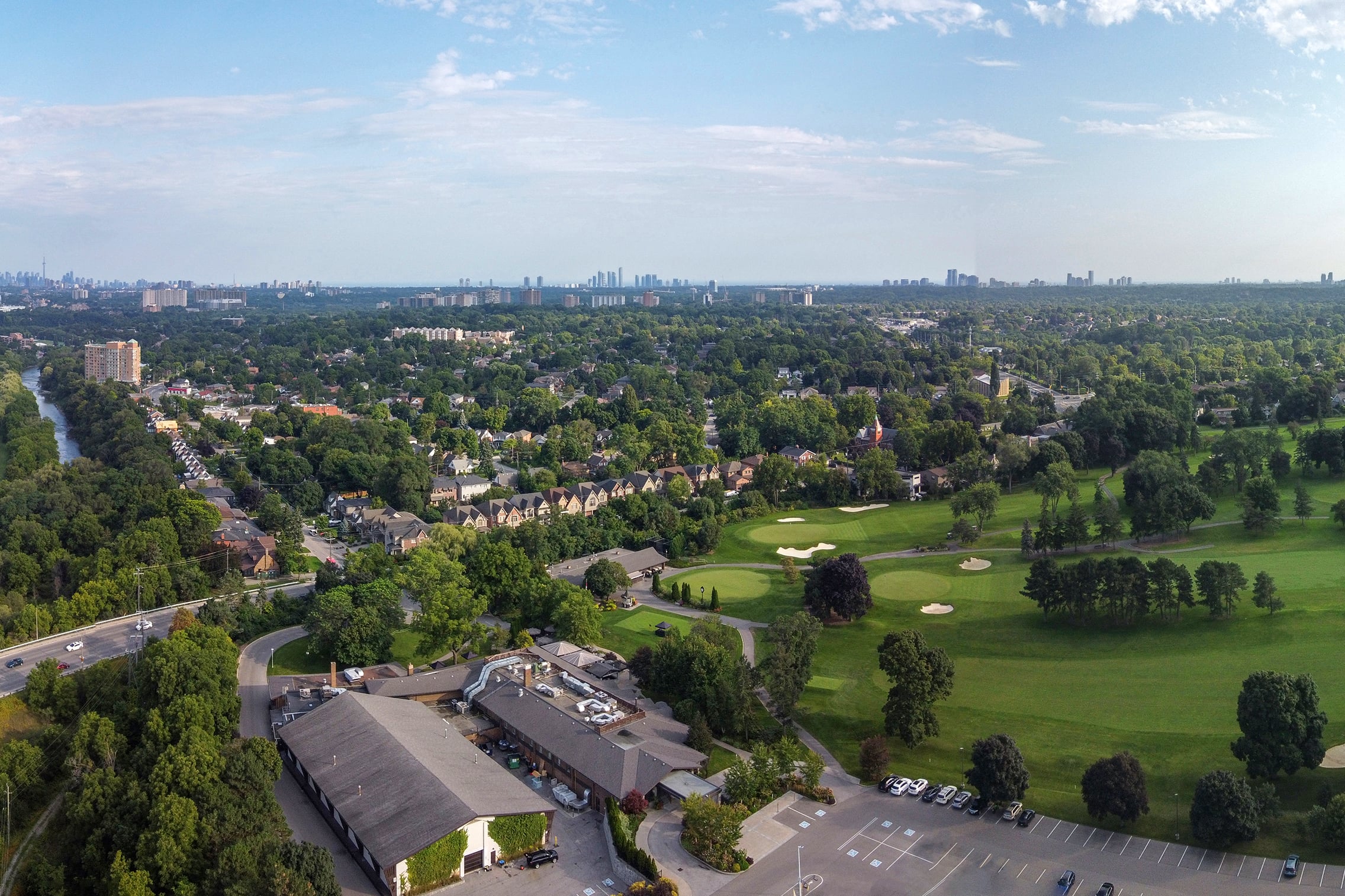 Aerial view of Humber Heights-Westmount homes, trees and Weston Golf and Country Club, 2024
