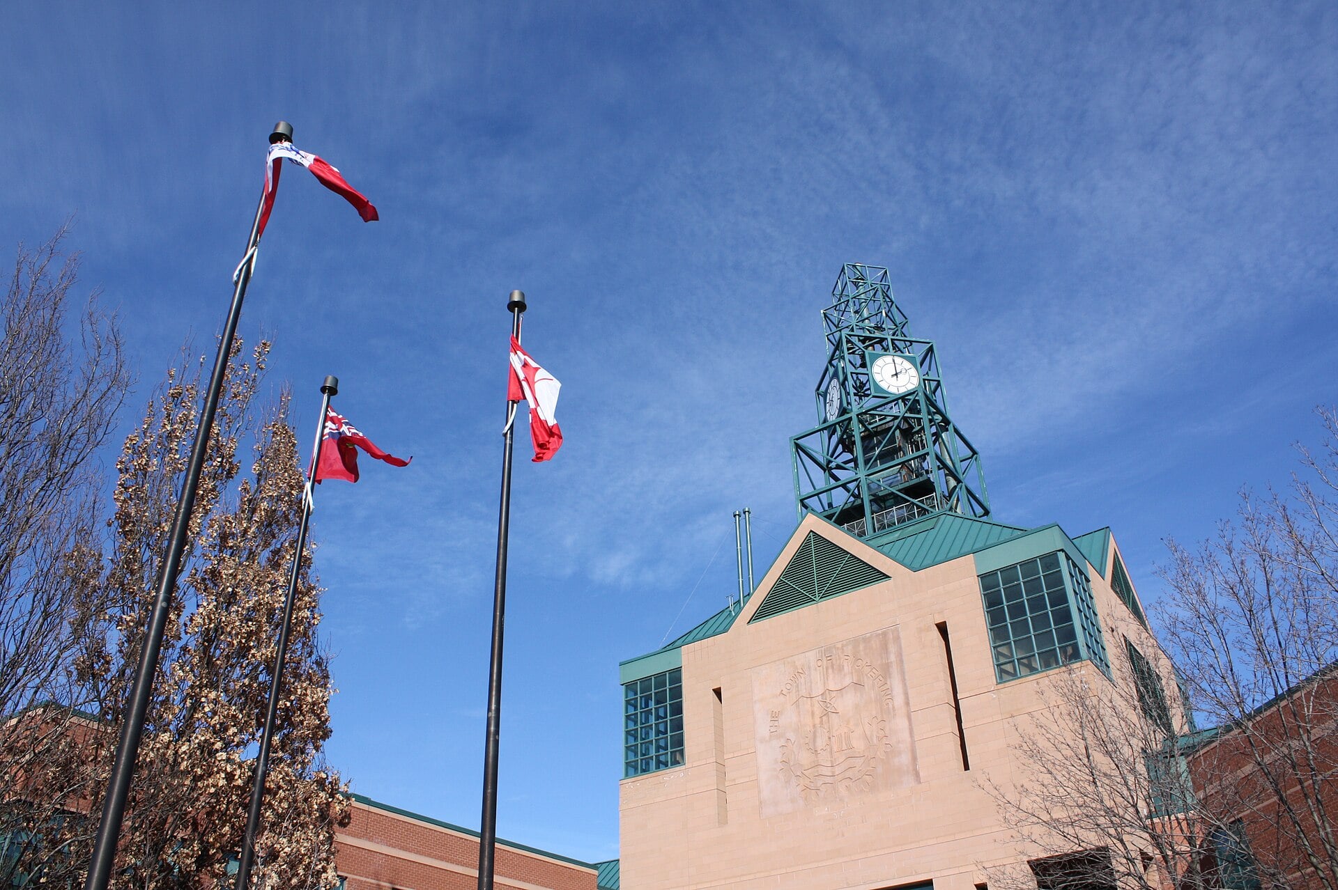 Clock and flags at the entrance to Pickering City Hall in Town Centre