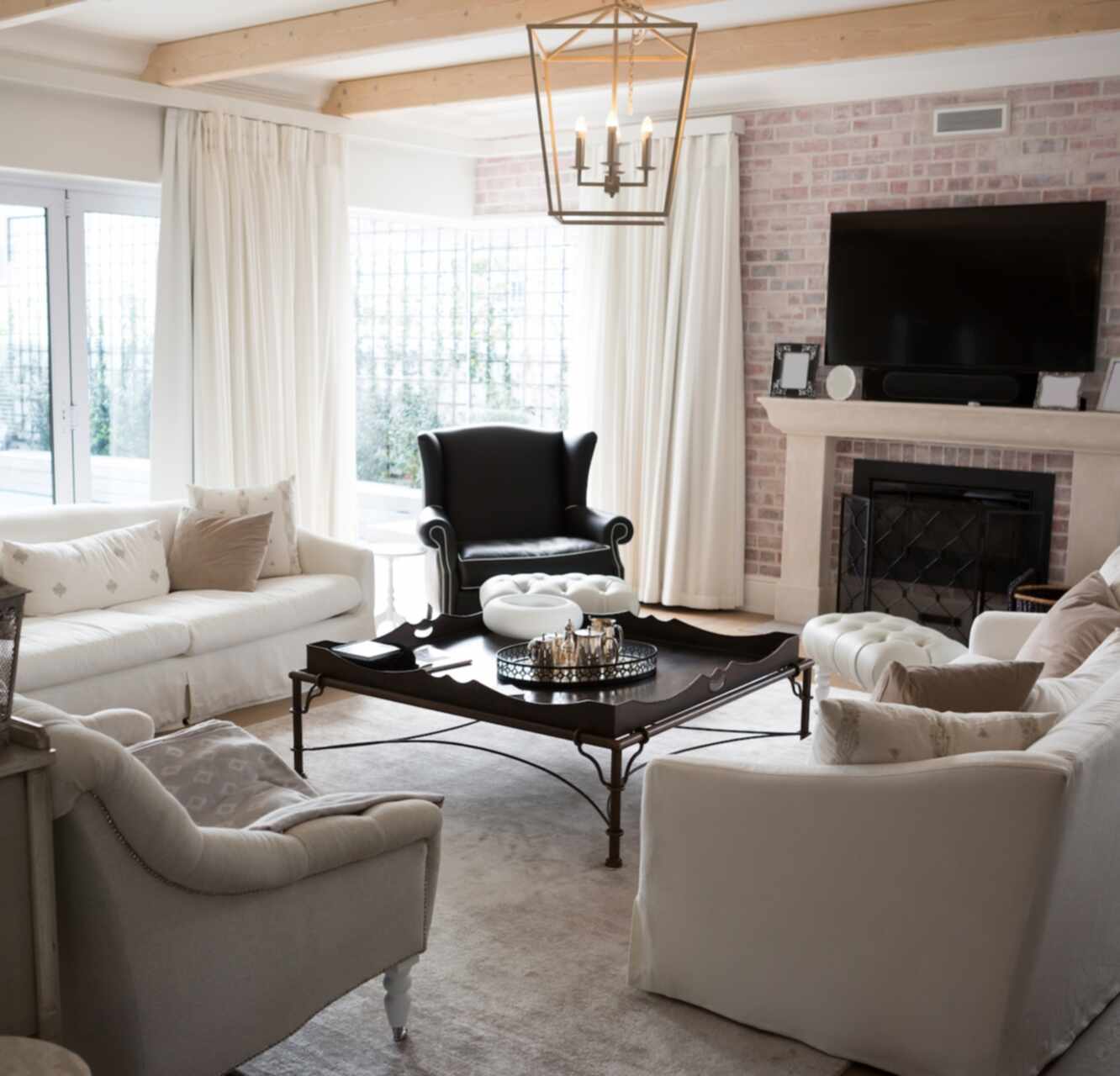 Elegant traditional living room with stone fireplace and wood beams