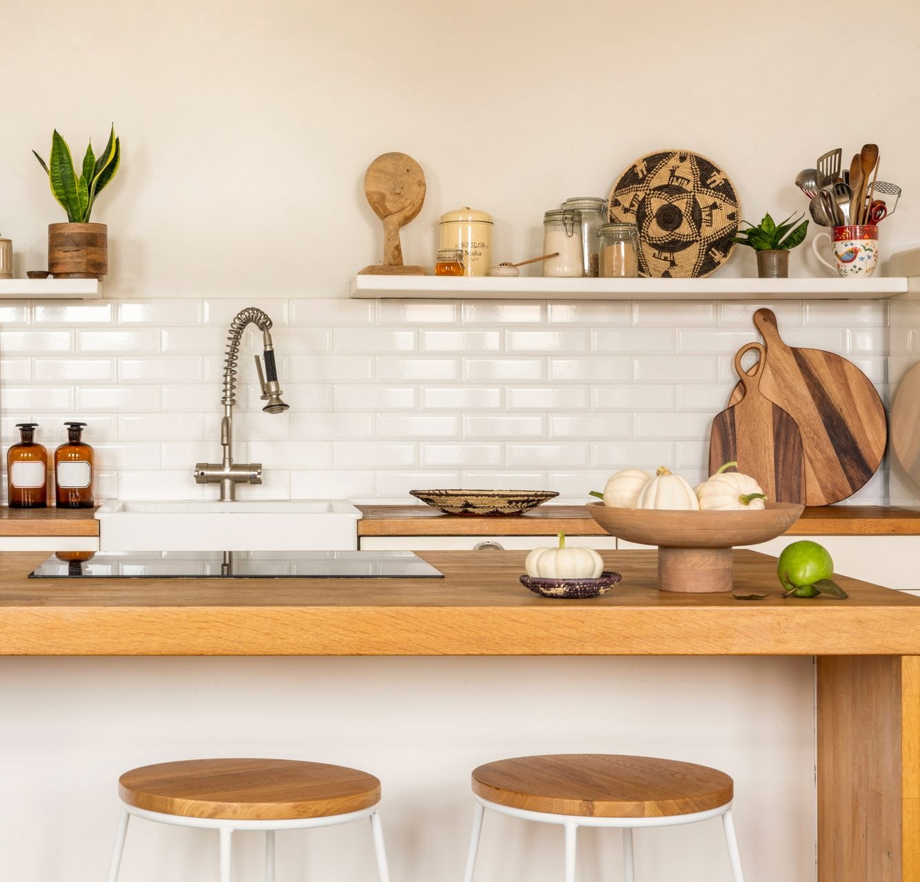 Warm kitchen with a wood island and stools in an Adams Township PA home