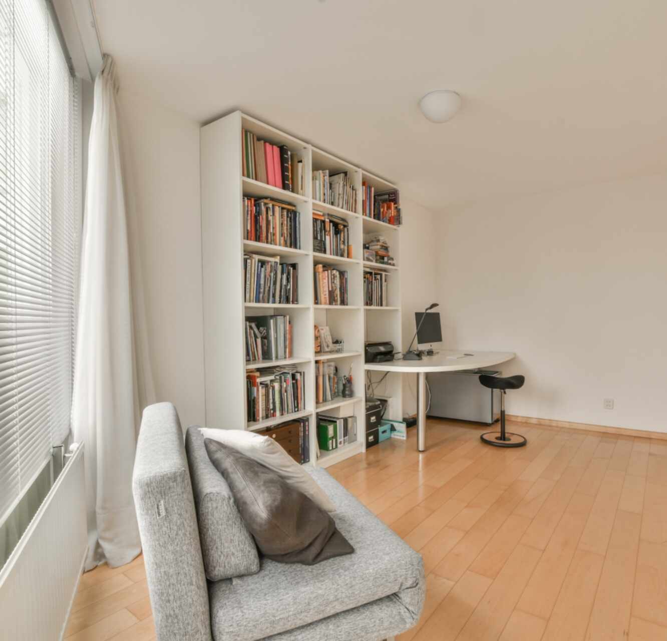 Bright family home study nook with built-in bookshelves
