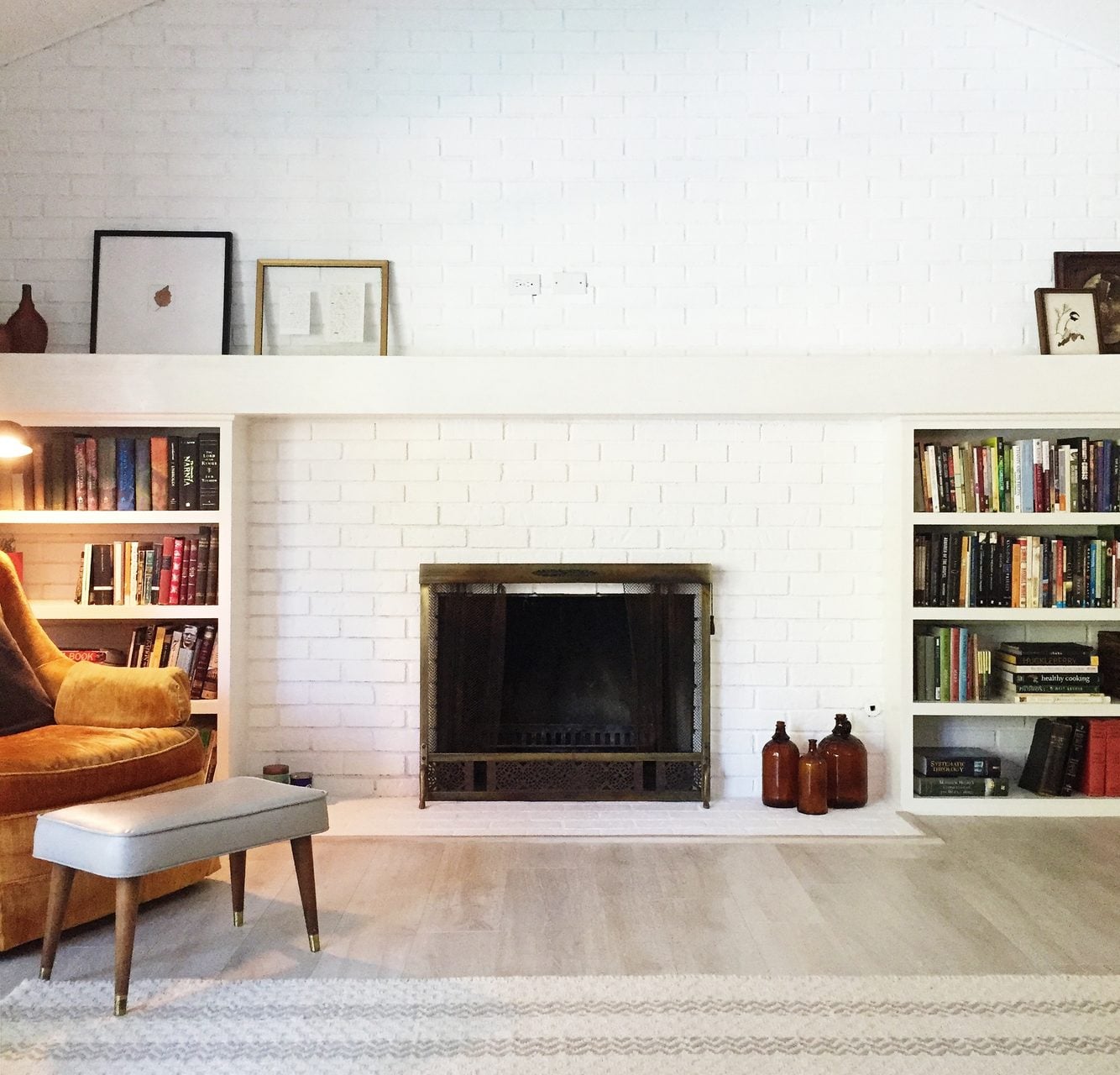 Cozy living room with white brick fireplace and built in bookshelves in a Seven Fields PA home