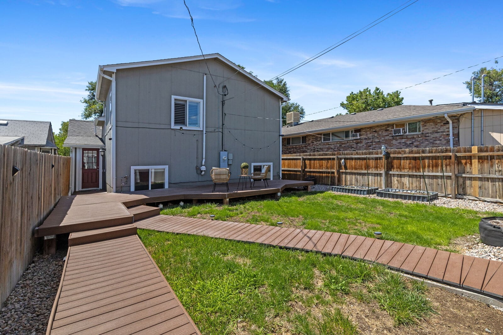 Private backyard with an extended deck and detached flex room at 1424 Tamarac St in East Colfax, Denver