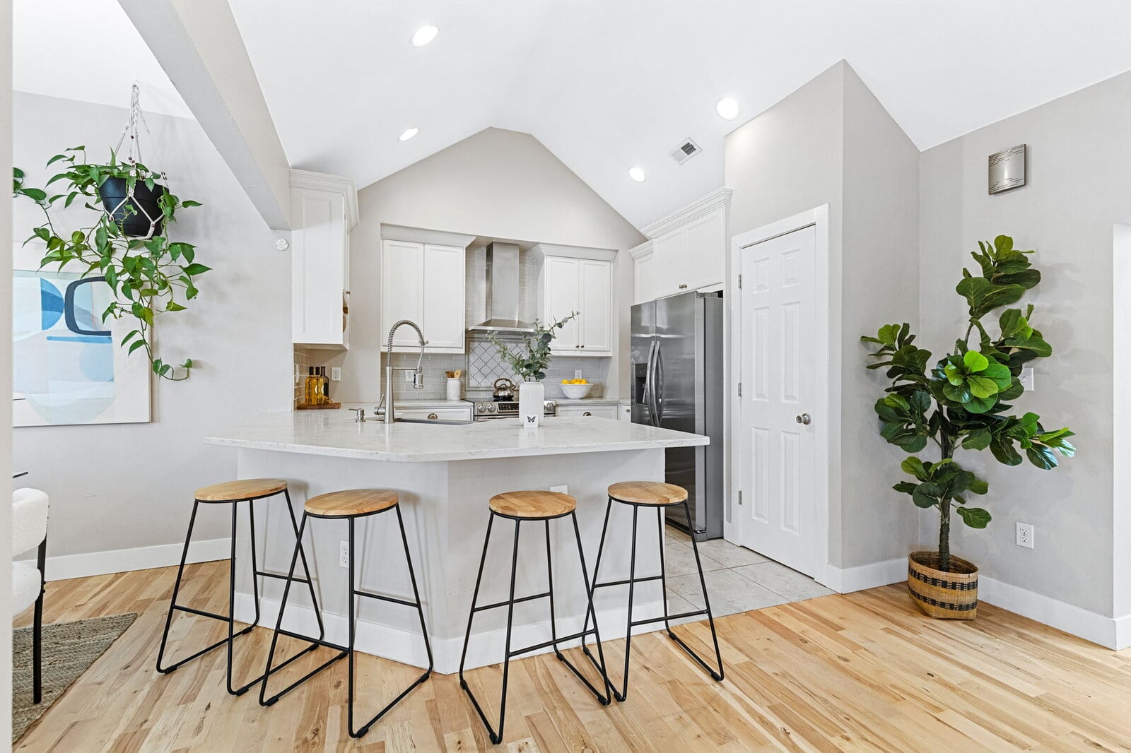 Updated kitchen with granite countertops, stainless steel appliances and vaulted ceilings at 1424 Tamarac St in East Colfax, Denver