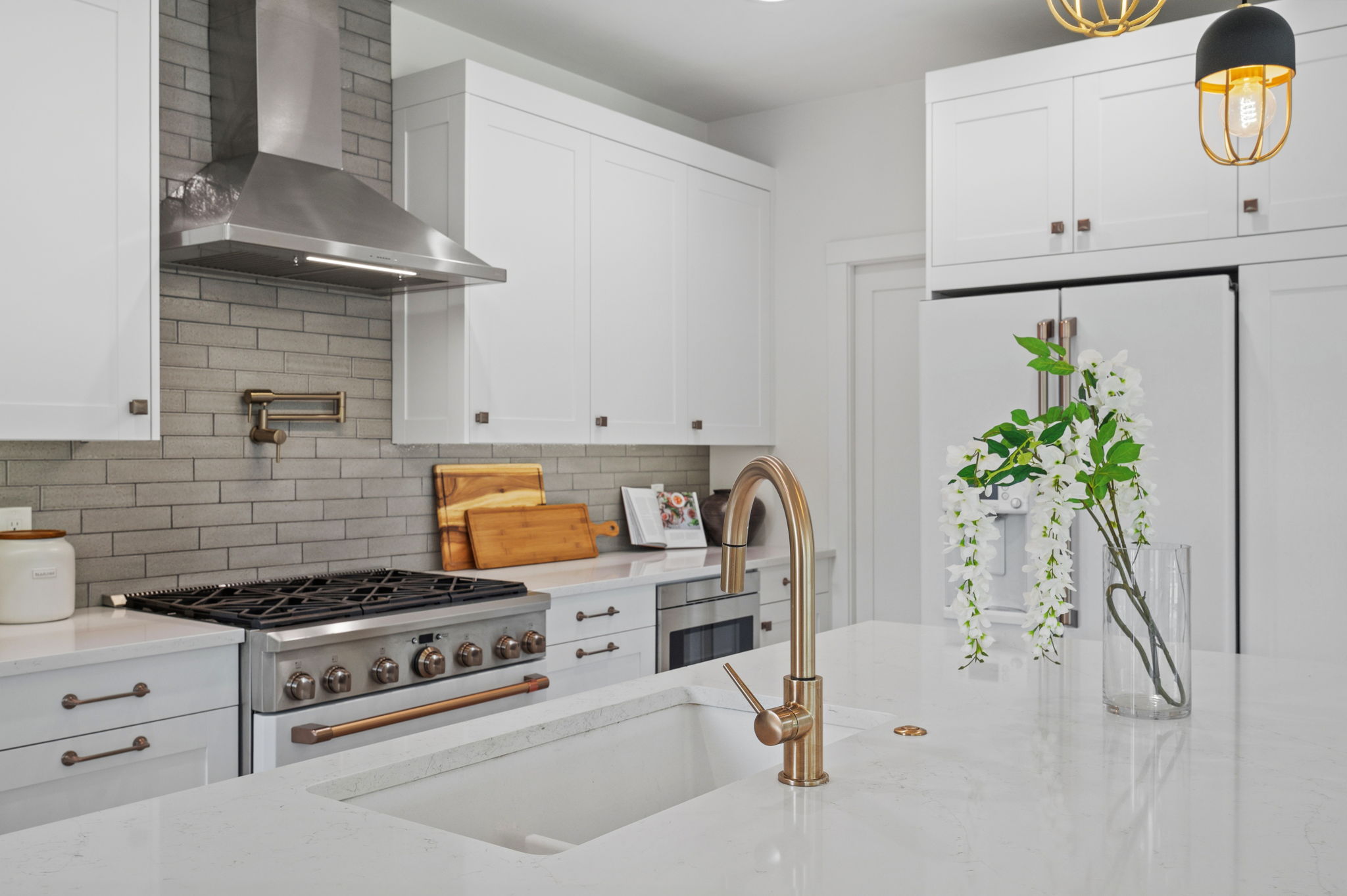 Chef’s kitchen with waterfall quartz island in a custom Littleton CO home for sale | FORM at Compass Denver