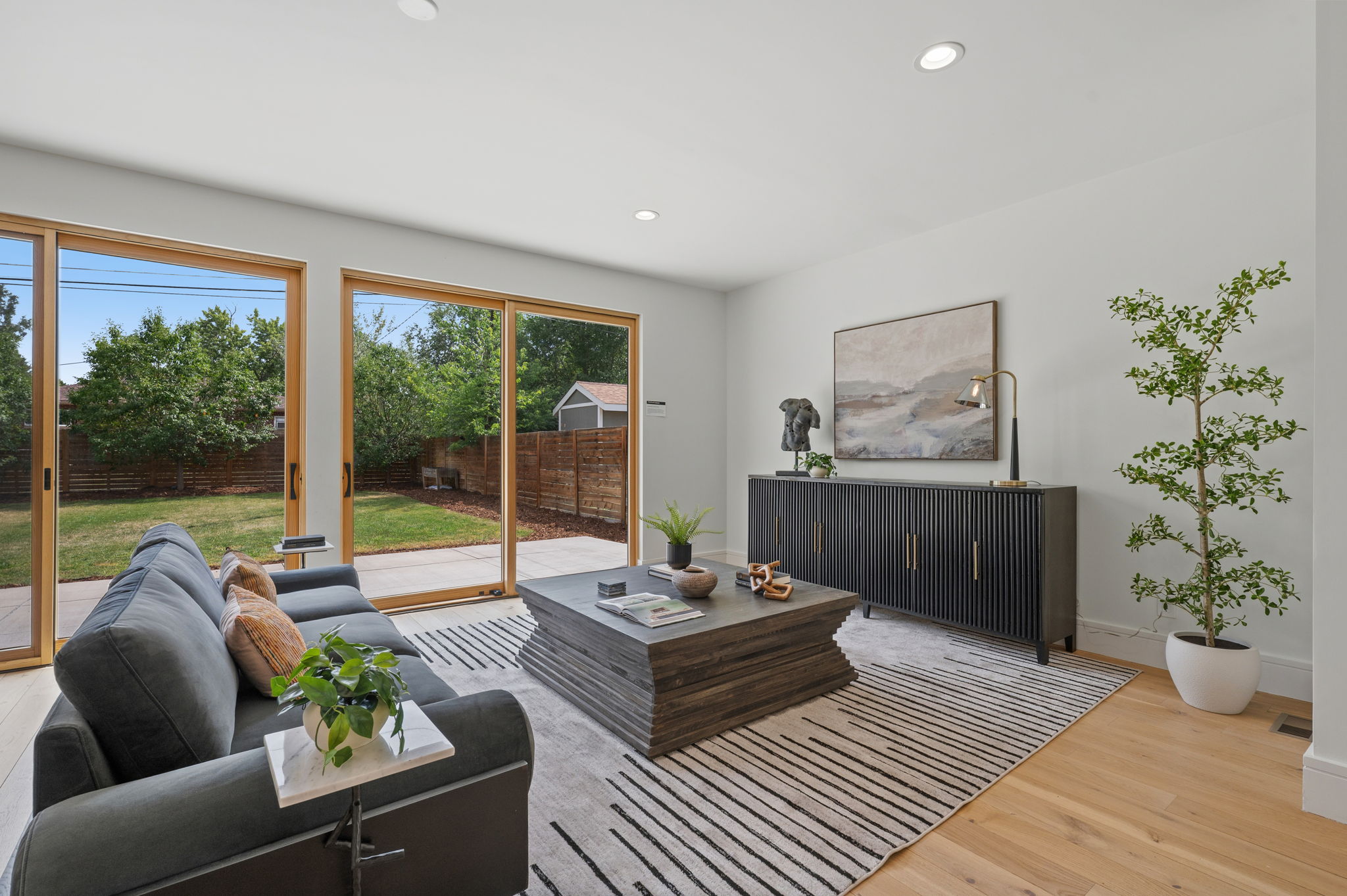 Twin sliding glass doors opening to the backyard of an Old Littleton home for sale | FORM at Compass Denver