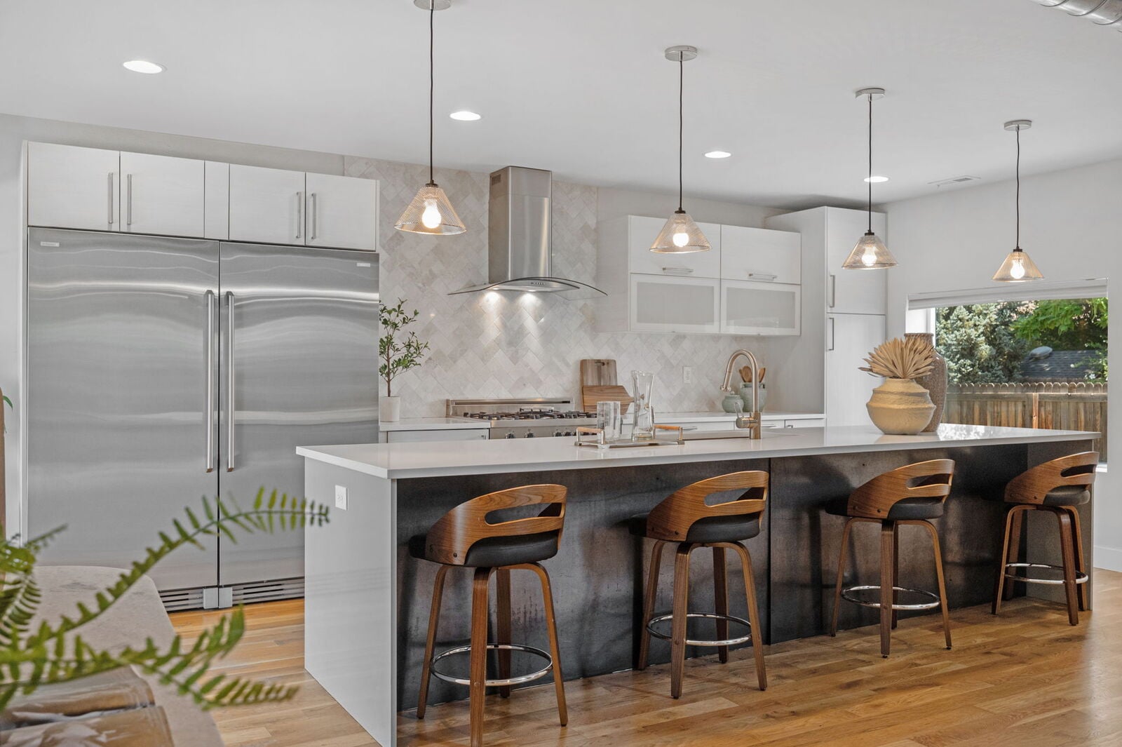 Chef's kitchen with large center island and range at 3801 W Alice Pl in Berkeley, Denver