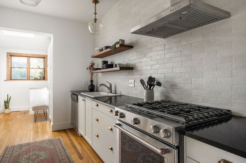 Remodeled kitchen with gas range and subway tile at 475 N Washington St in Alamo Placita, Denver