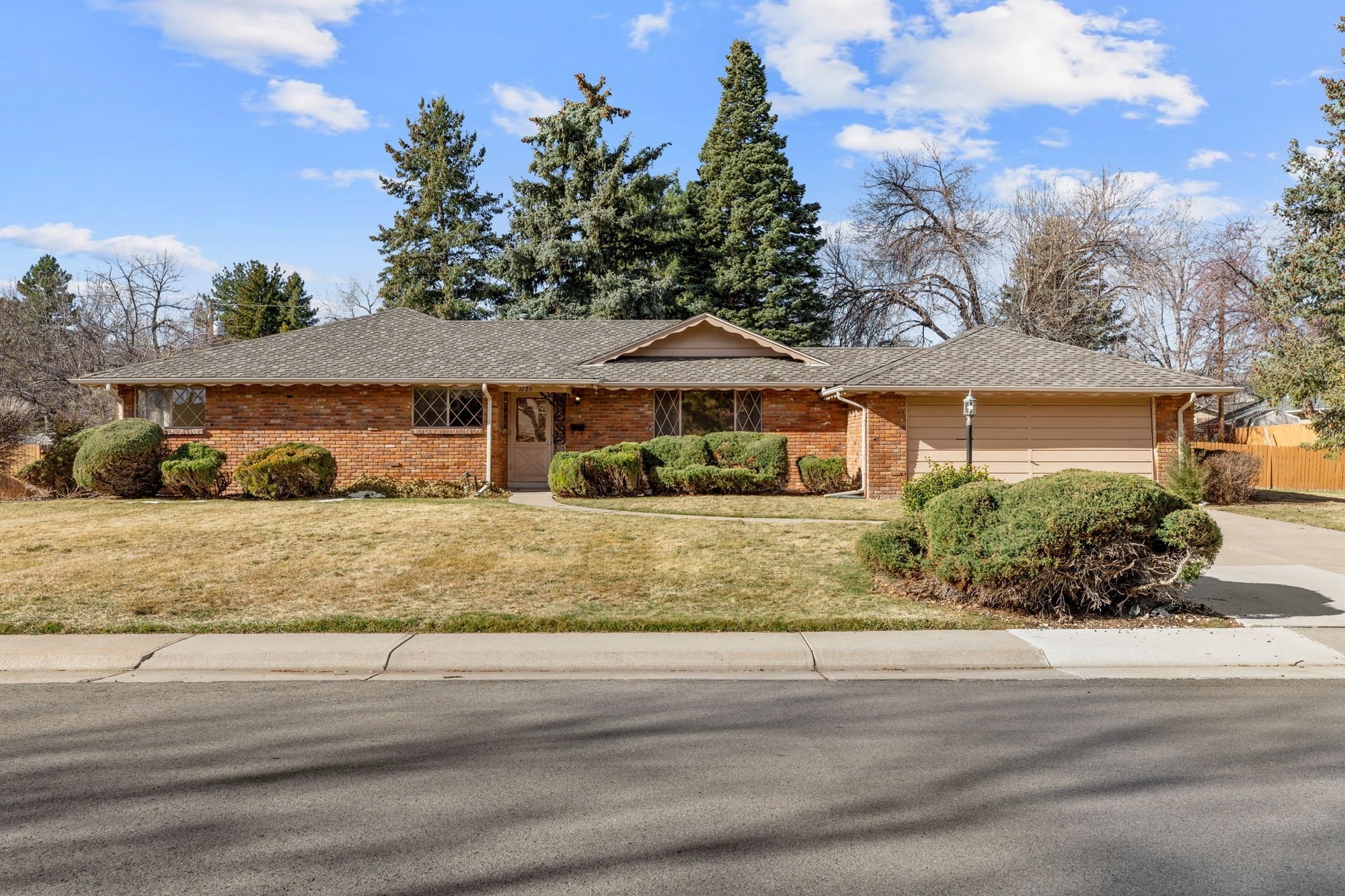 Mid-century brick ranch home on a tree-lined street in Applewood, Colorado