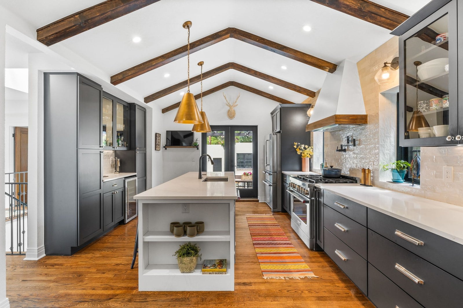 Renovated kitchen with updated cabinets, counters and lighting in an Applewood-area home