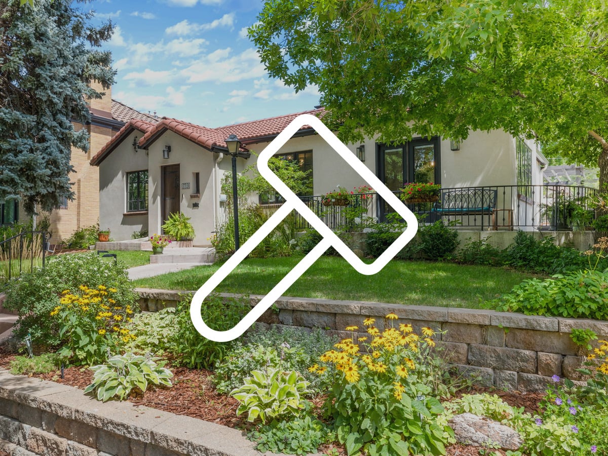 Spanish-style stucco home with mature landscaping in Belcaro, Denver, considered for renovation before selling