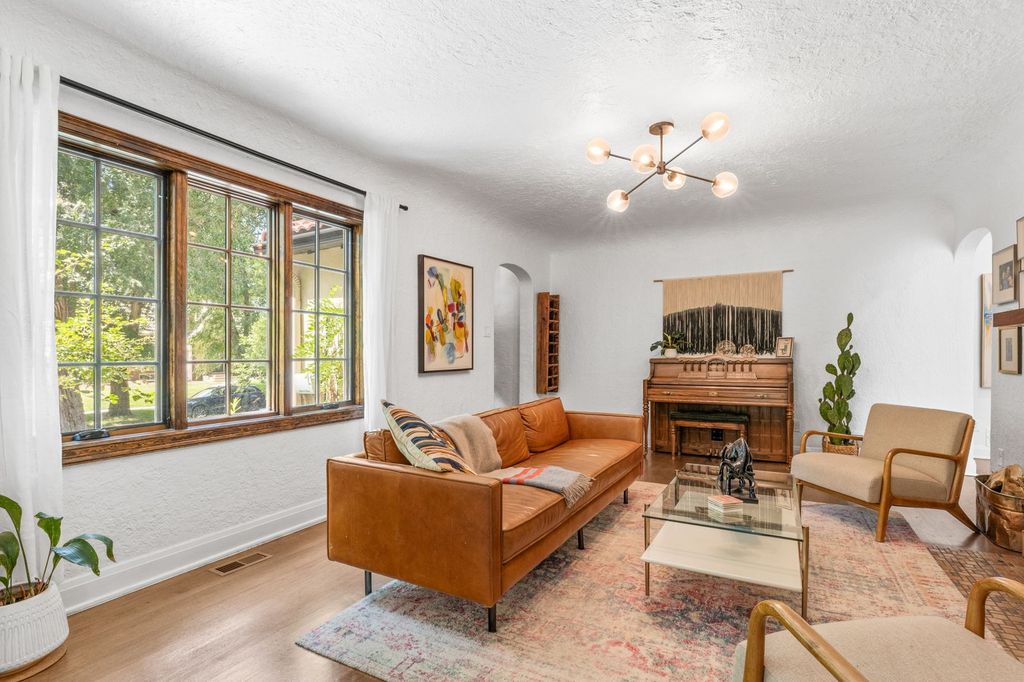 Living room with refinished hardwood floors, fresh paint and updated lighting in a Belcaro, Denver home