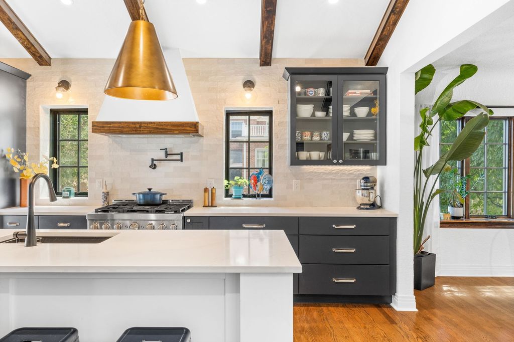 Renovated kitchen with dark cabinetry and marble backsplash in a Belcaro, Denver home