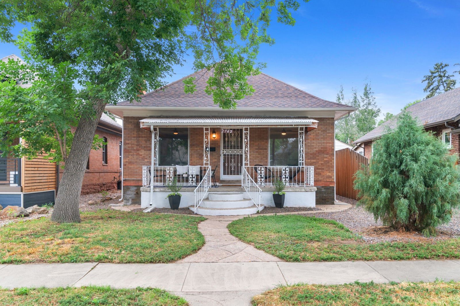 Classic Denver brick bungalow with a front porch, typical housing stock for Chicago transplants