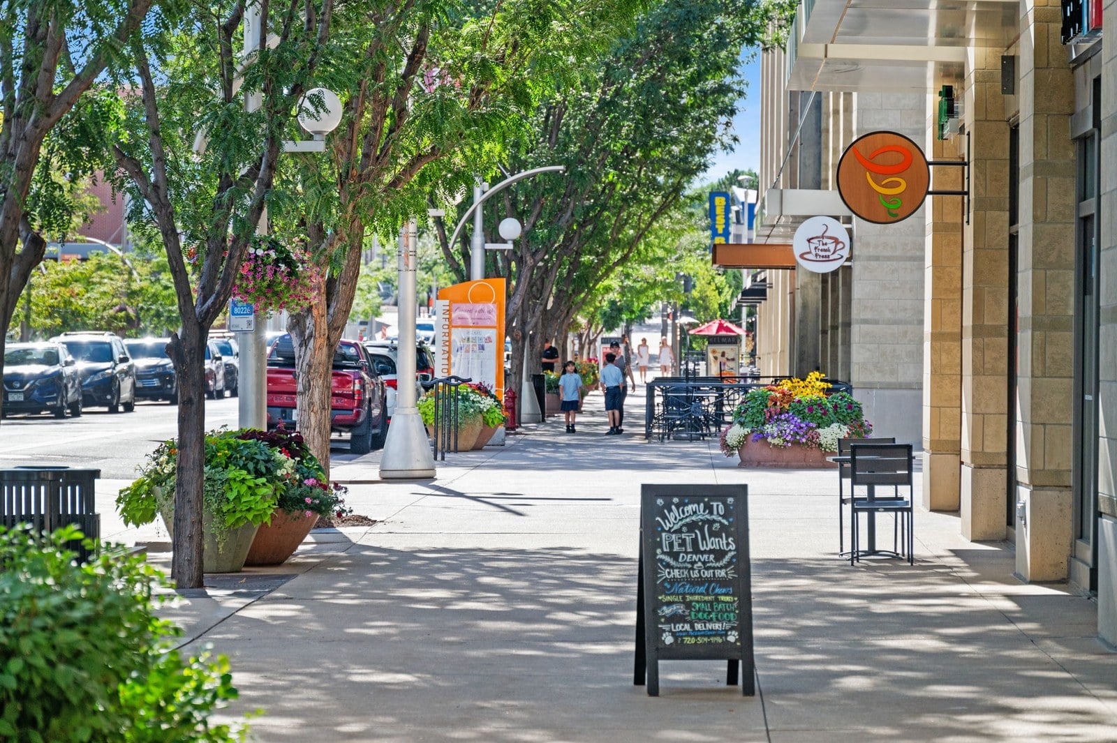 Shop-lined sidewalk in a walkable central Denver neighborhood