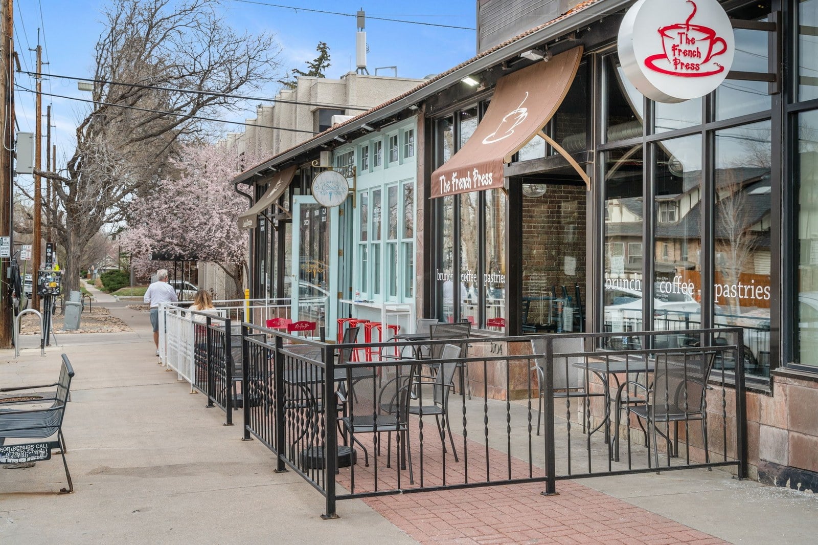 Shop-lined sidewalk in a walkable Denver neighborhood