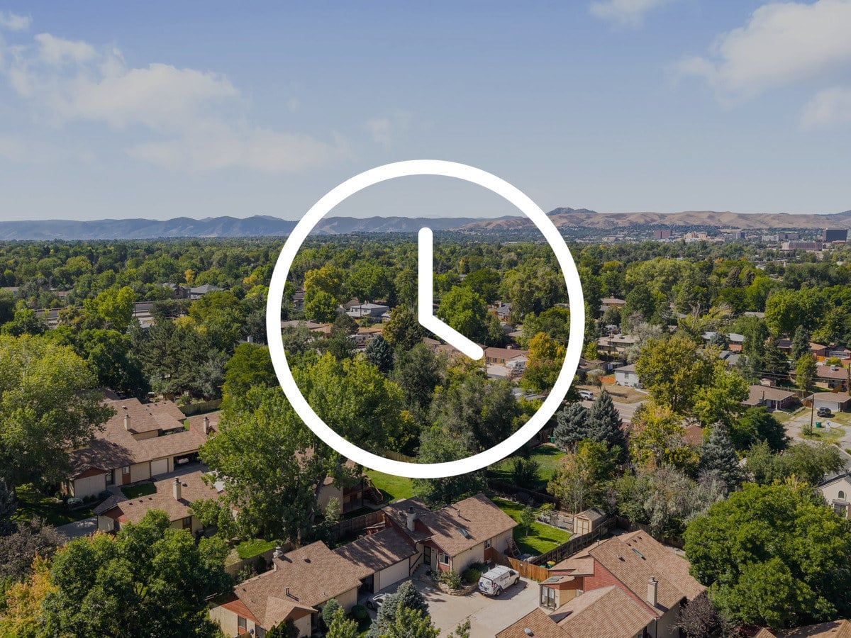 Aerial view of a tree-lined Denver neighborhood near Washington Park with the foothills beyond