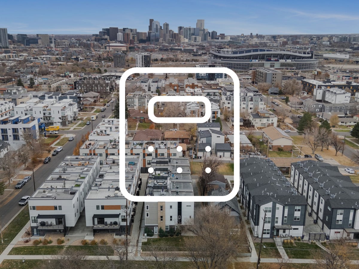 Aerial view of Denver townhomes and the downtown skyline illustrating what it costs to buy a home in Denver