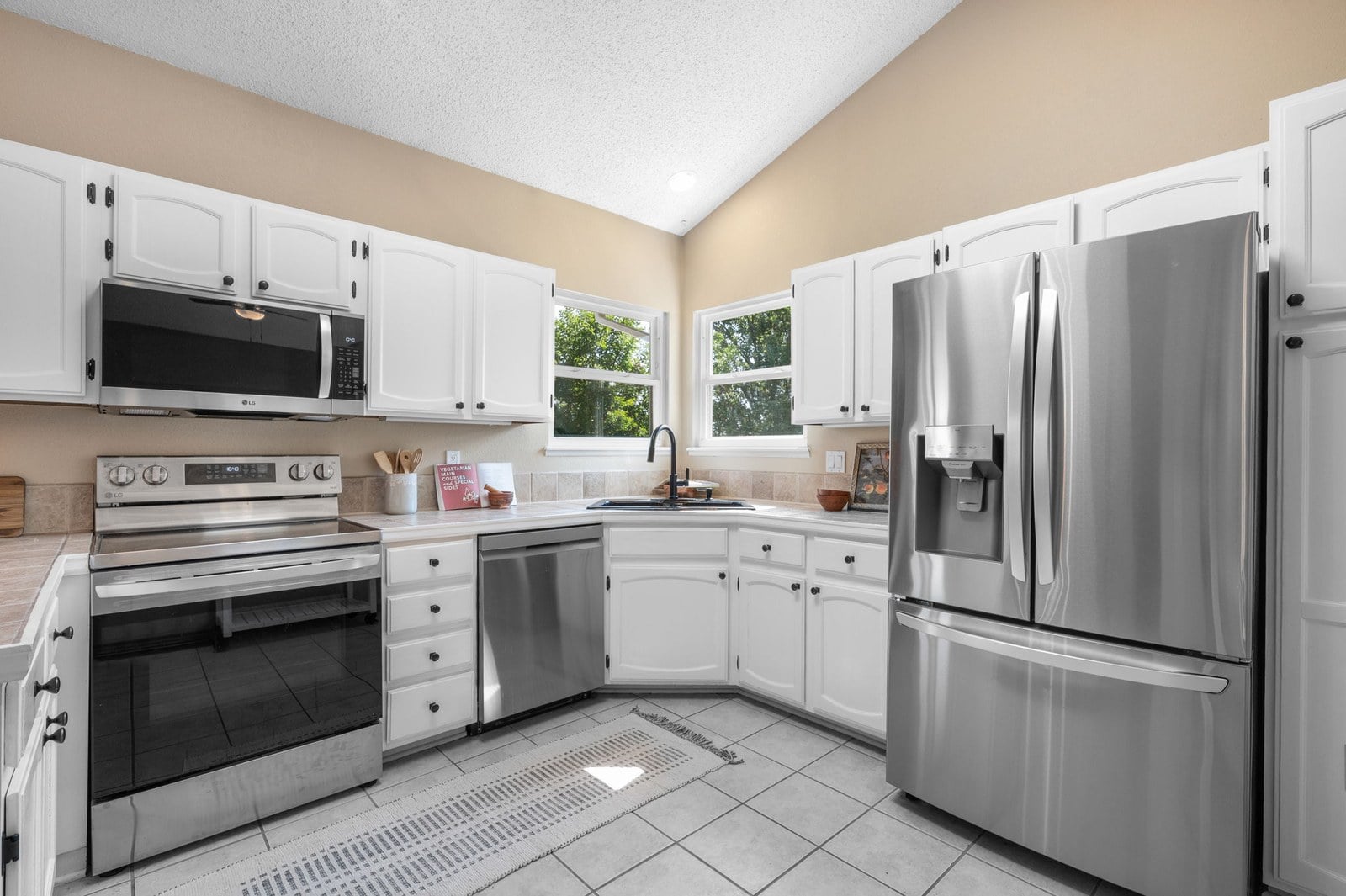 Updated kitchen with new stainless appliances and island at 12221 W Prentice Pl in Littleton, Colorado