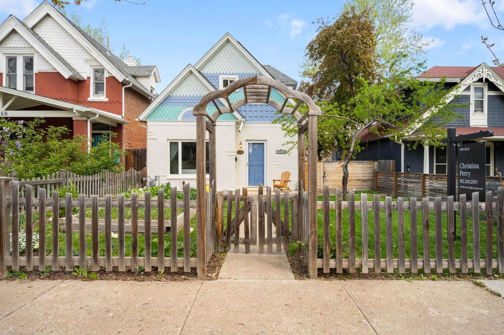 Historic Denver homes with mature trees and a picket fence near Washington Park