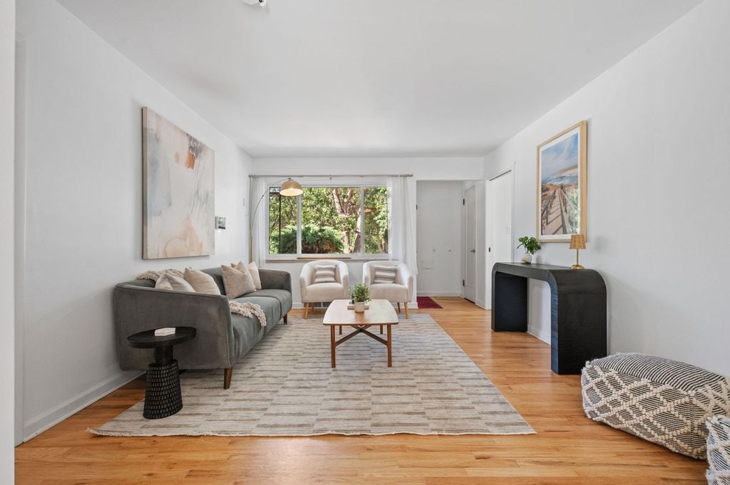 Light-filled living room with hardwood floors in a renovated ranch at 2740 S Madison St, Wellshire, Denver