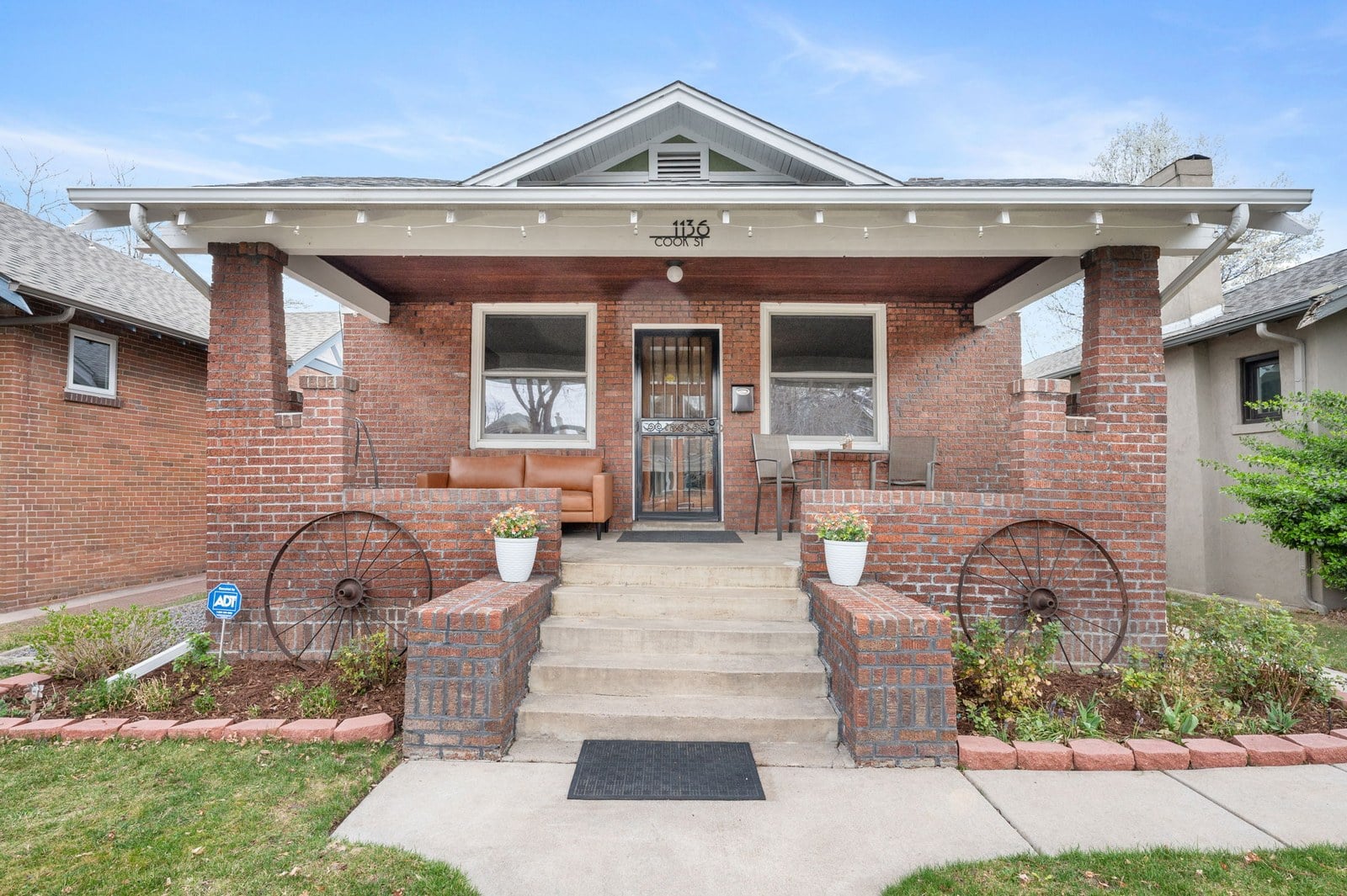 Brick craftsman bungalow with a covered front porch in the Berkeley neighborhood of Denver, Colorado