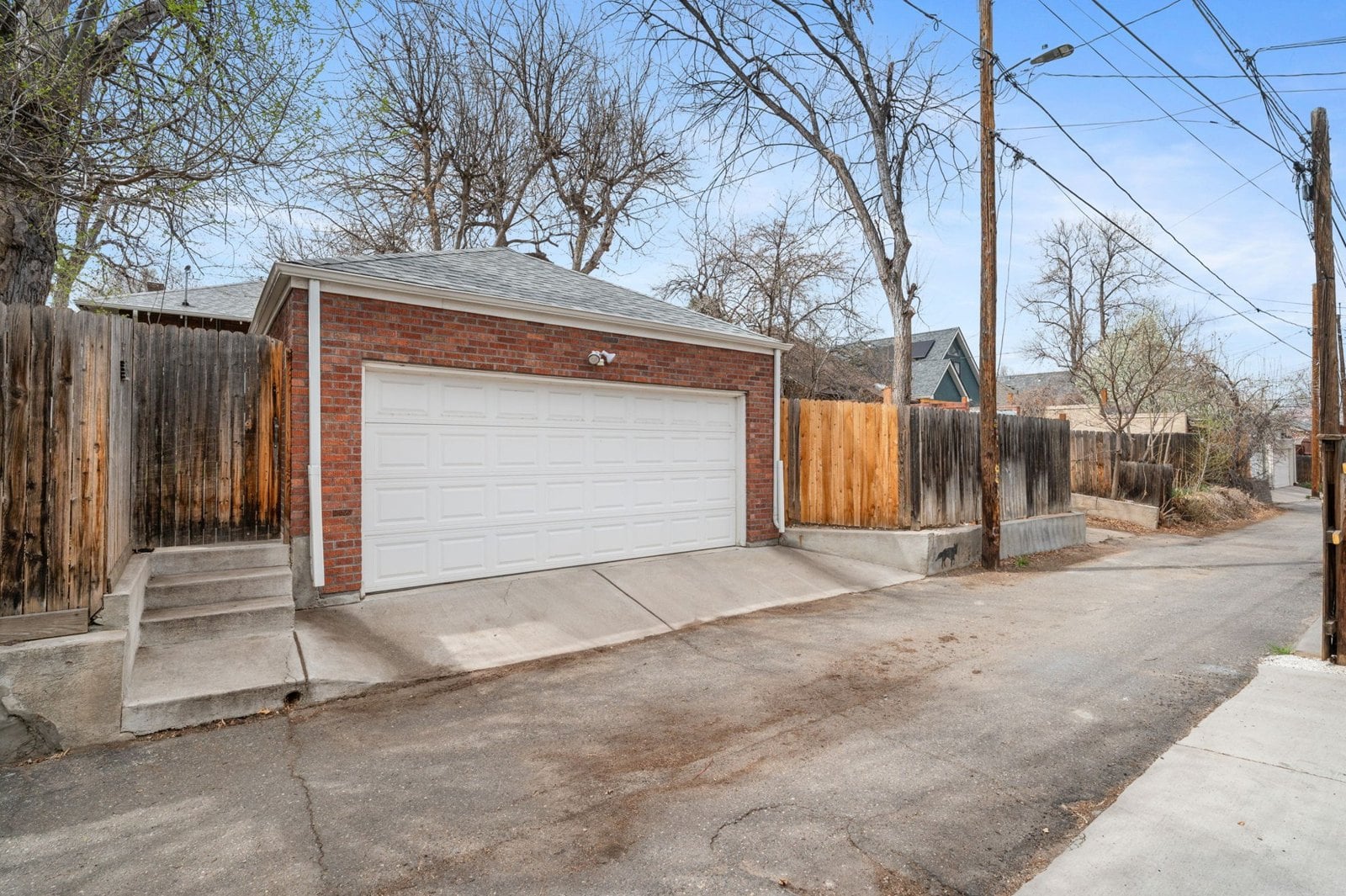 Two-car detached brick garage off the alley behind a Denver home