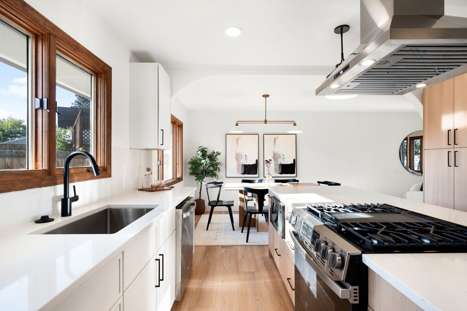 Updated white kitchen with an island and stainless appliances in an older Denver home