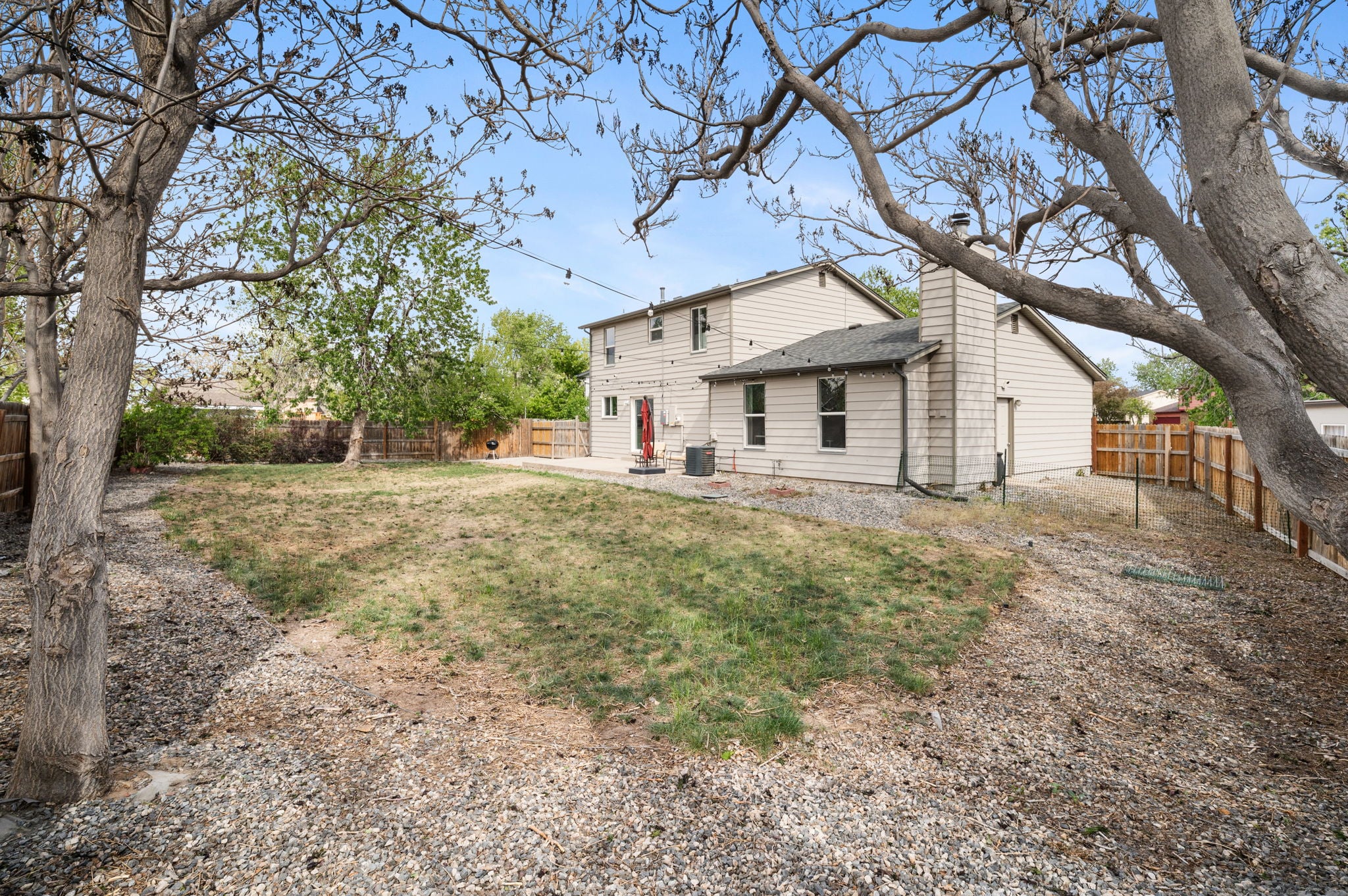 Fenced backyard and rear elevation of a Wheat Ridge, Colorado home