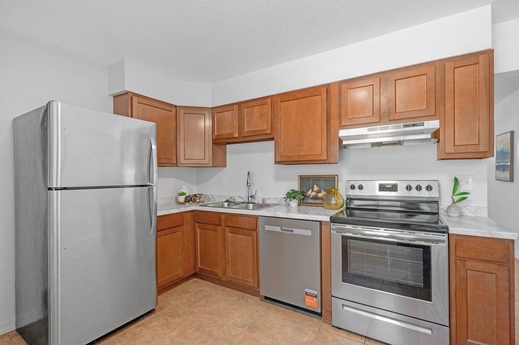 Kitchen with stainless steel appliances at 5504 Sable St in Montbello, Denver