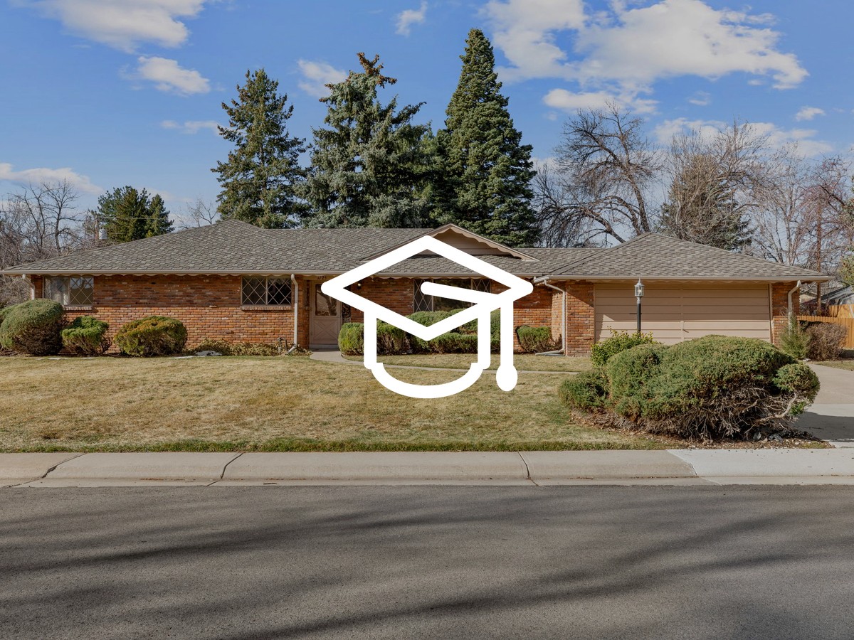 Brick ranch home with a two-car garage, front lawn and tall evergreen trees