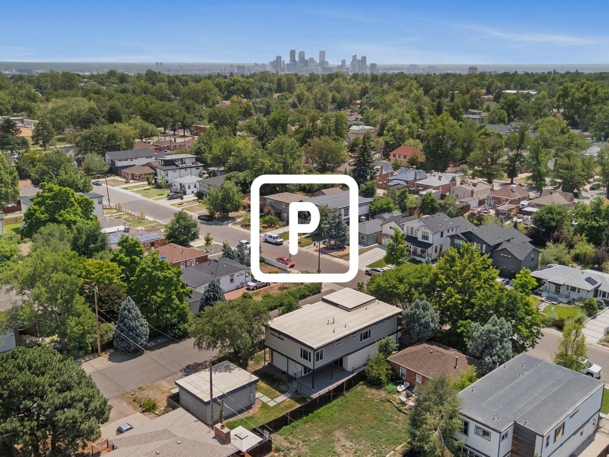 Aerial view of a residential neighborhood with the downtown Denver skyline in the distance