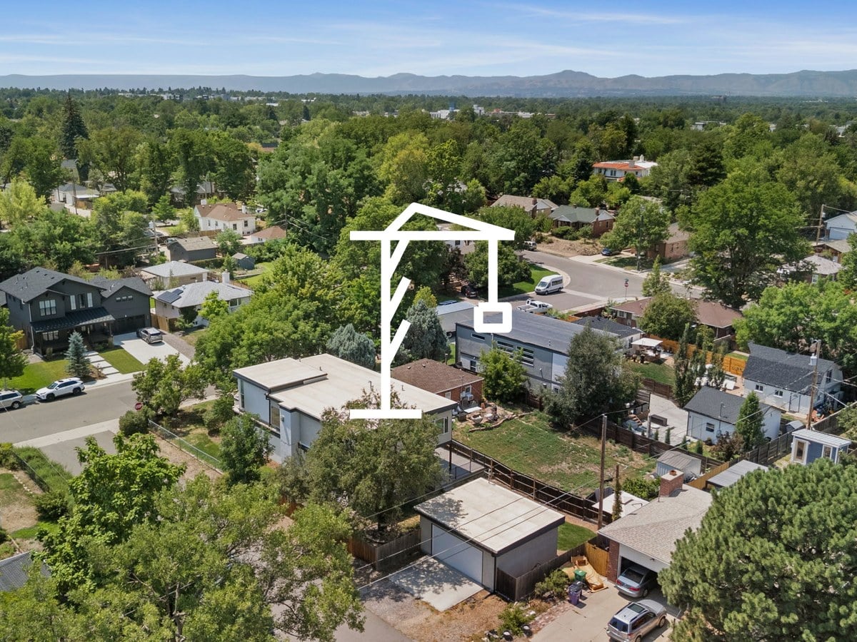 Aerial view of tree-lined residential streets with mountains on the horizon