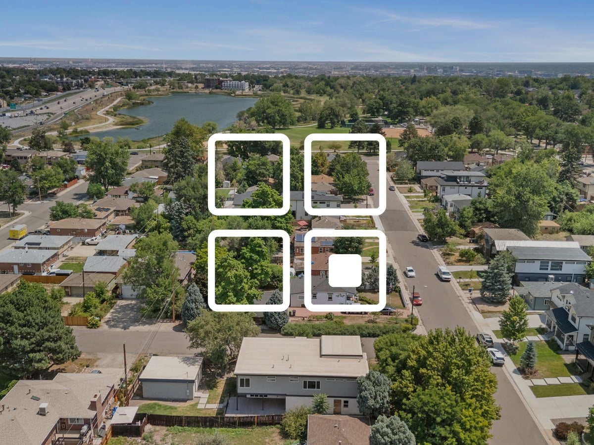 Aerial view of tree-lined blocks of single-family homes and a city lake