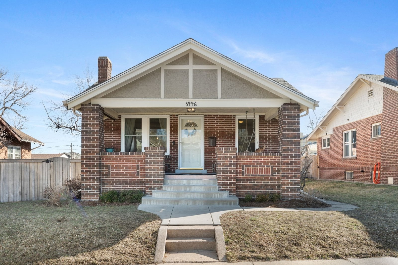 Brick bungalow with a front-gabled porch and wide front steps in northwest Denver