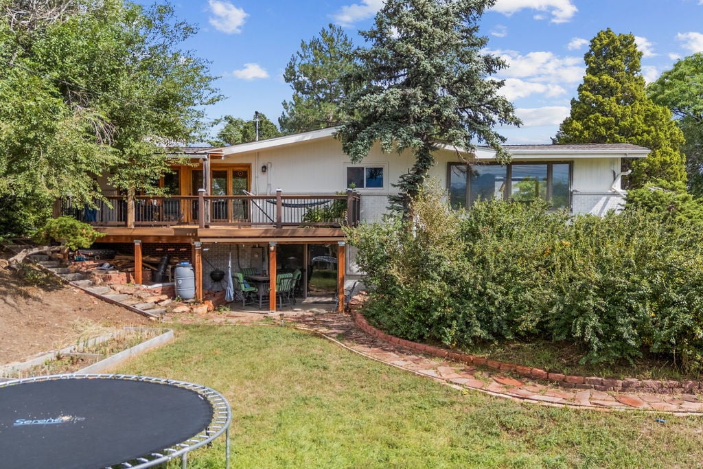 Raised wood deck and sloped backyard at a Wheat Ridge, Colorado home