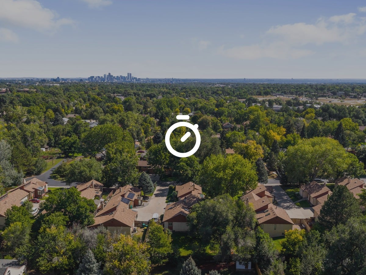 Aerial view of Wheat Ridge, Colorado homes with the Denver skyline on the horizon