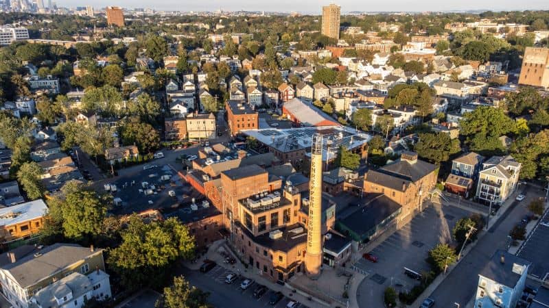 Centre Street in Jamaica Plain, Boston, with local storefronts and pedestrians — capturing the neighborhood’s walkable, community‑driven atmosphere for people considering moving in 2025.